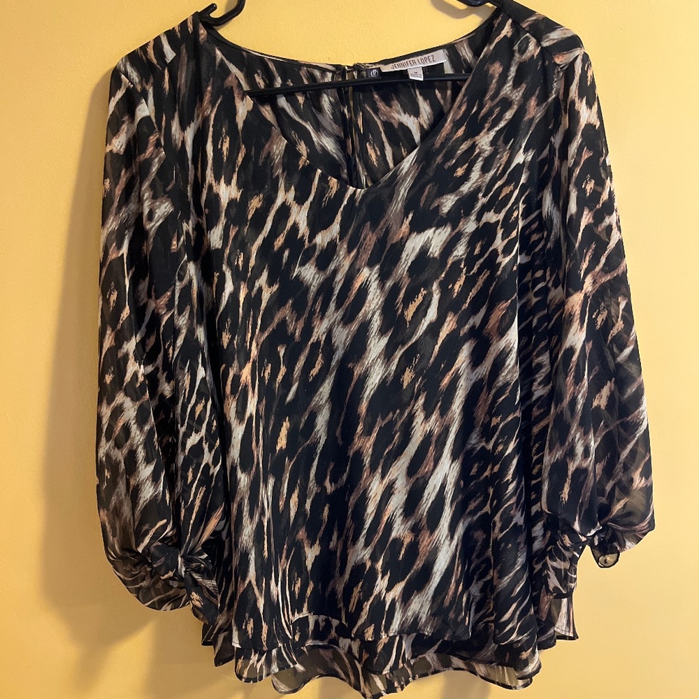 Jennifer Lopez- Blouse in animal print- wide sleeves—lightweight material.